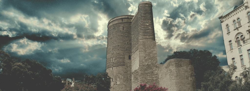 a stone tower with a cloudy sky