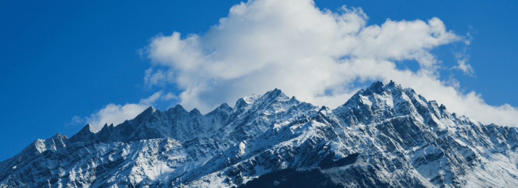 A majestic snowy mountain under a clear blue sky, showcasing the beauty of winter landscapes.