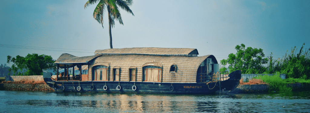A charming houseboat resting on the water, offering a cozy retreat amidst a scenic aquatic landscape.