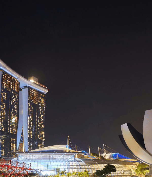 a city skyline with a large building and a sculpture