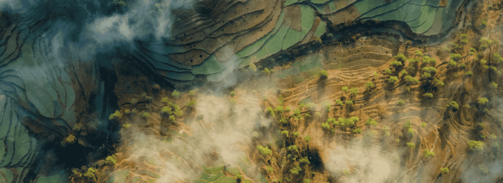 Aerial view showcasing the lush, green rice terraces of Sapa, Vietnam, highlighting their intricate patterns and natural beauty.
