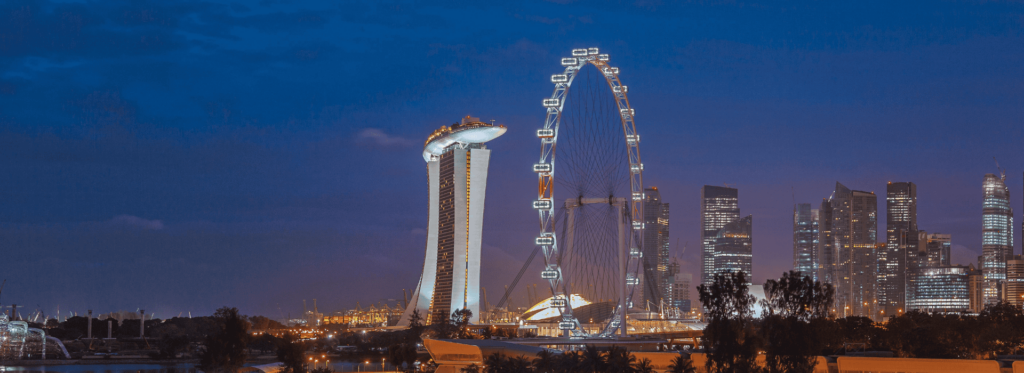 The skyline of Singapore aglow at night, featuring iconic buildings and a captivating urban landscape.