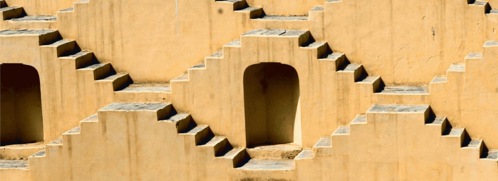 A close-up view of a textured wall featuring numerous windows, showcasing their varied shapes and sizes.