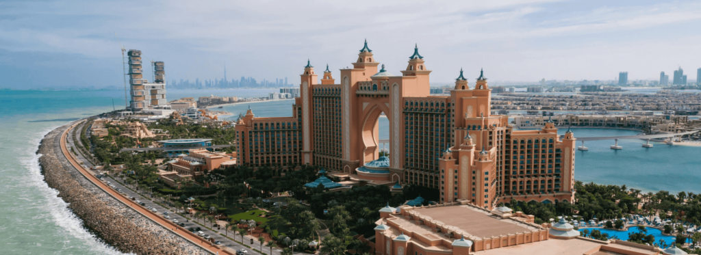 The Atlantis Hotel in Dubai, featuring its grand facade and beautiful landscaping, epitomizing luxury and elegance.