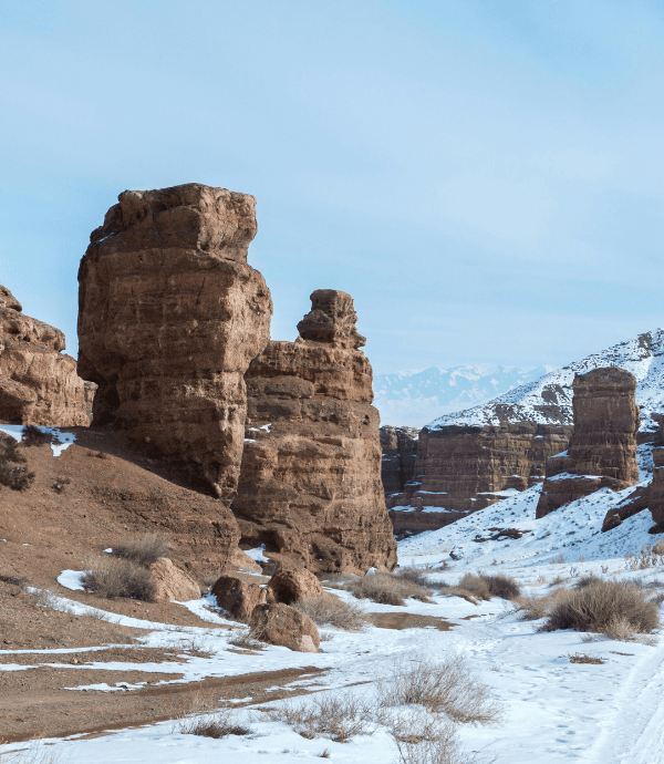 a rocky landscape with snow and mountains