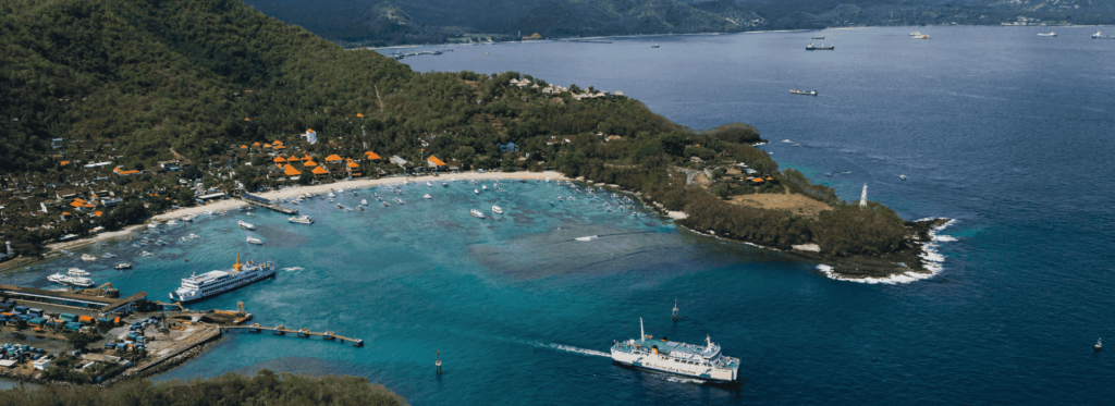 A boat glides smoothly on the water's surface, surrounded by a tranquil environment.