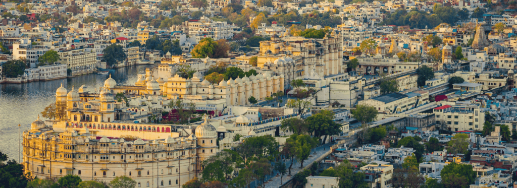 A scenic depiction of Udaipur, India, highlighting its beautiful lakes and historic palaces amidst lush greenery.