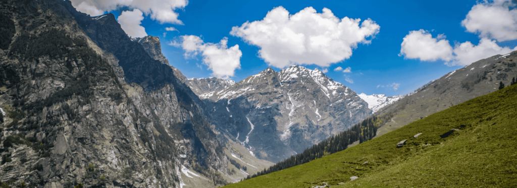 A tranquil valley set against a backdrop of towering mountains, capturing the essence of natural beauty and serenity.