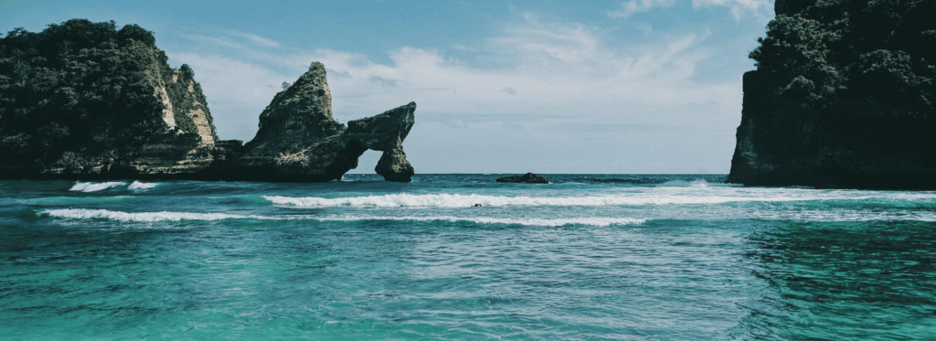 An ocean vista showcasing rugged rocks and dynamic waves, highlighting the beauty of nature's coastal landscape.