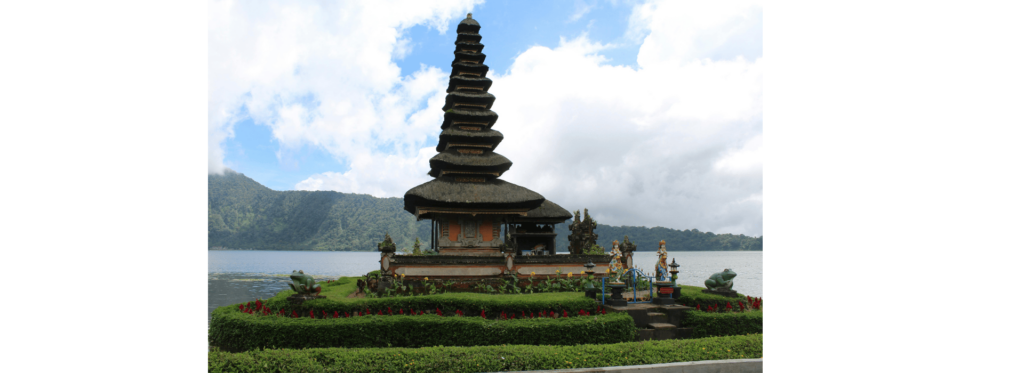 A towering statue of a man is positioned on a hill, providing a commanding view of the surrounding area.
