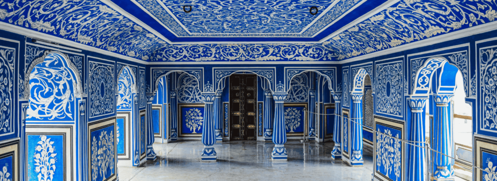 A blue and white hallway featuring intricate ornate designs along the walls and ceiling, creating an elegant atmosphere.