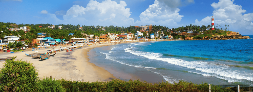 A serene beach scene featuring several houses and a tall lighthouse overlooking the calm waters.