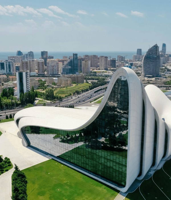 a building with a curved roof and a curved glass wall