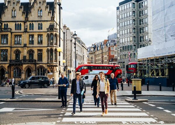 people walking on a crosswalk in a city