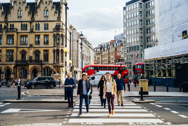 people walking on a crosswalk in a city