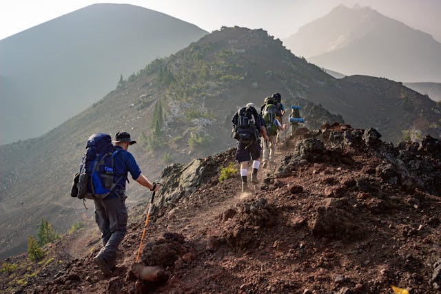 a group of people hiking on a rocky mountain